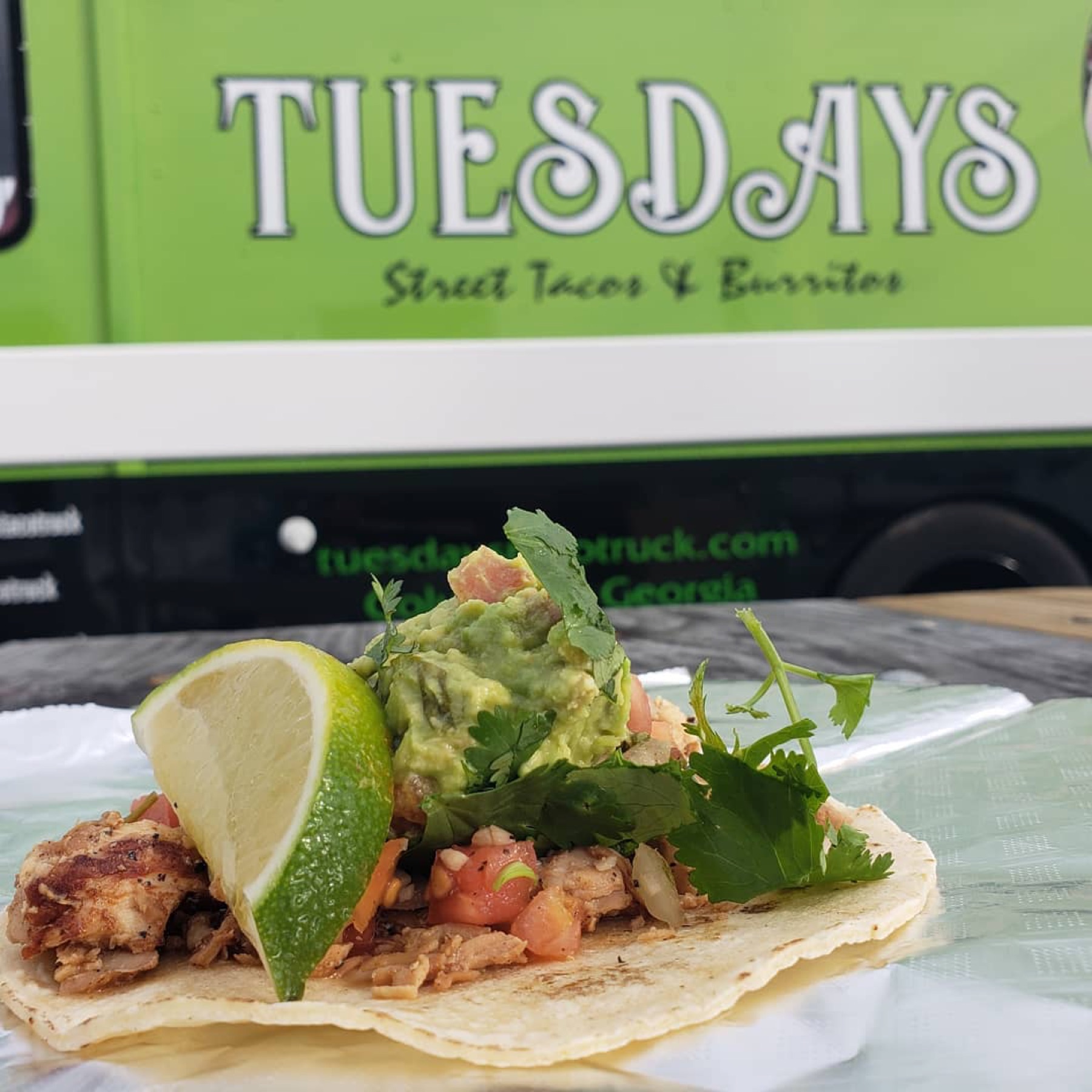 A Tuesdays street taco with lime, guacamole and cilantro
